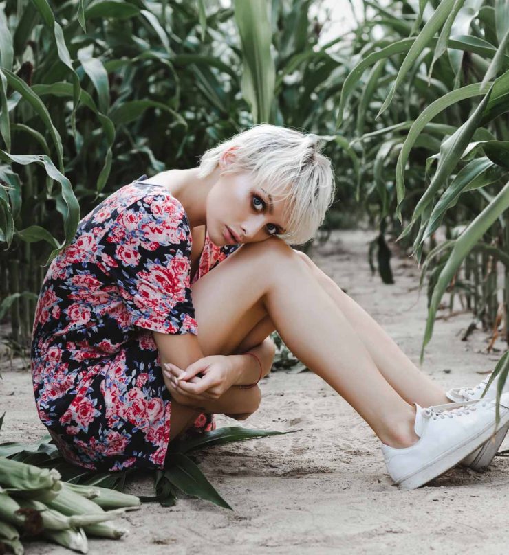 girl-between-green-leaves-in-a-corn-field-PD8U4Z5.jpg